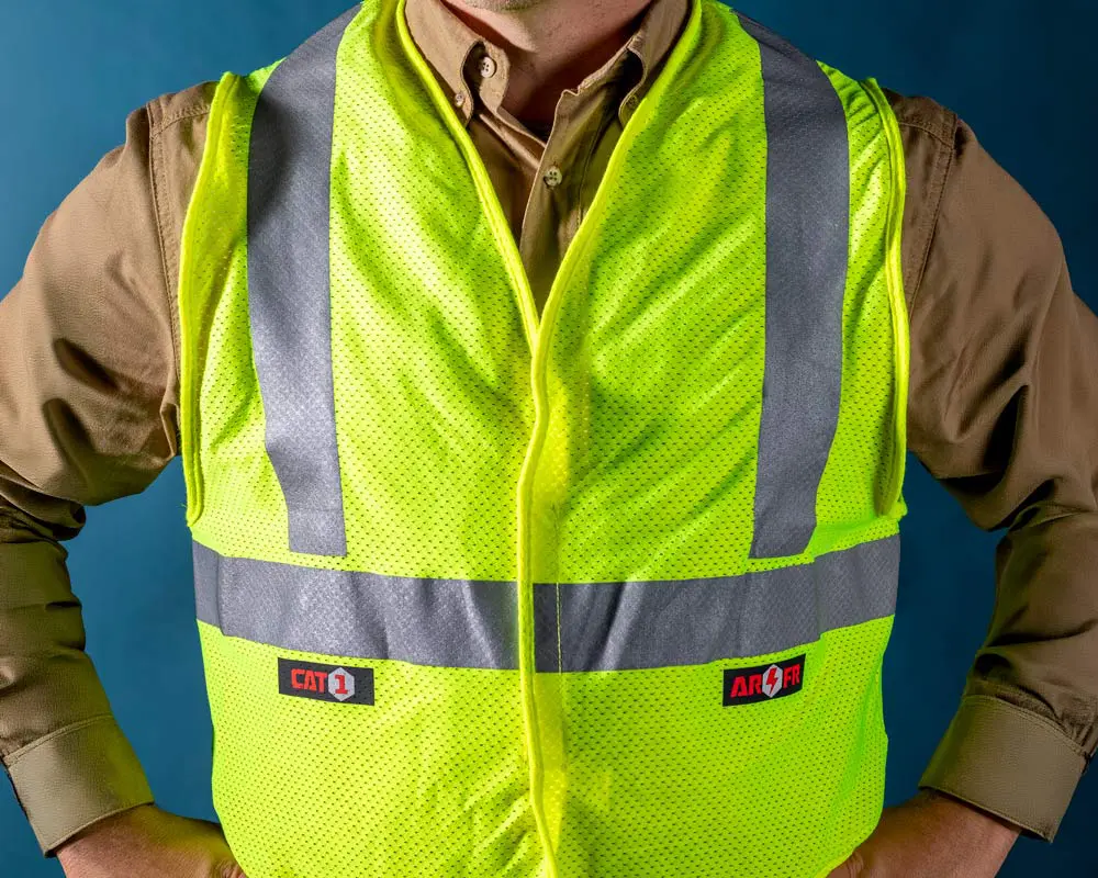 man in tan shirt and hi-vis vest